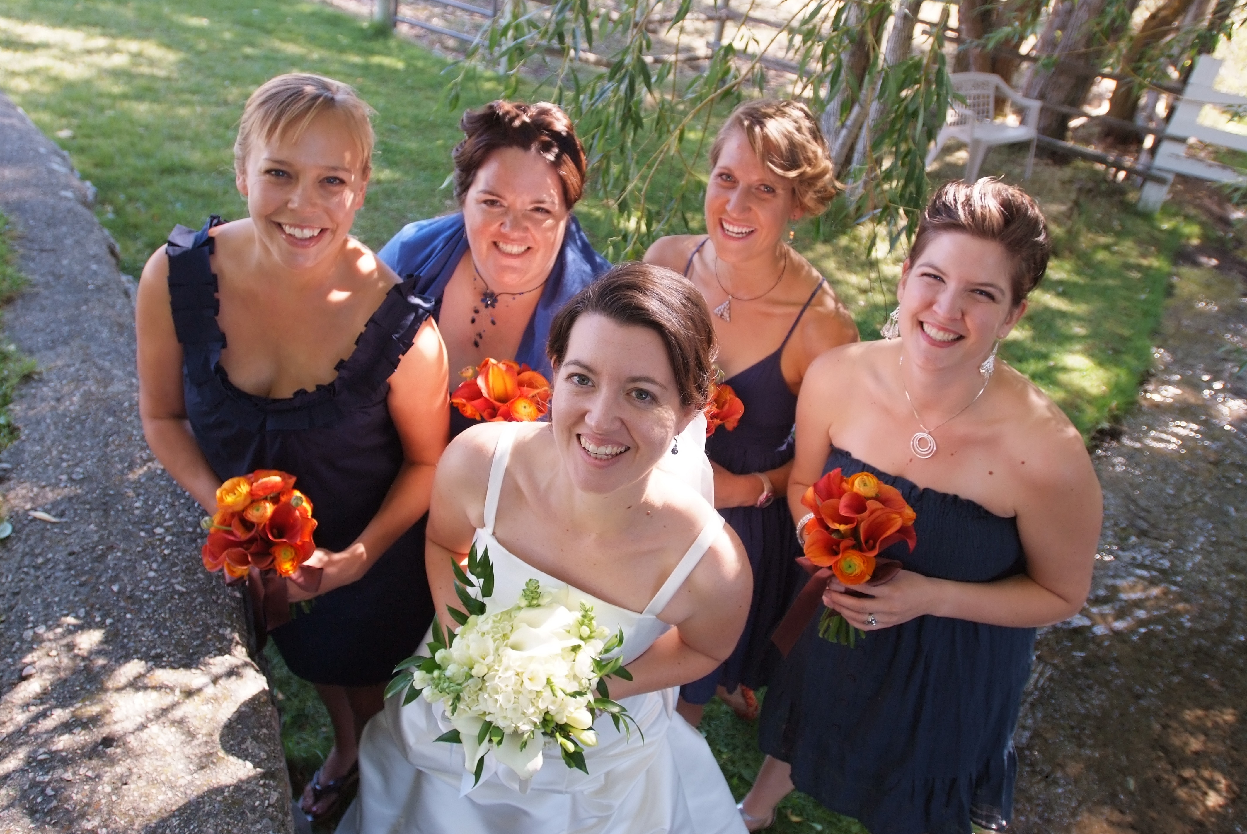 Navy blue bridesmaid dresses with orange flowers
